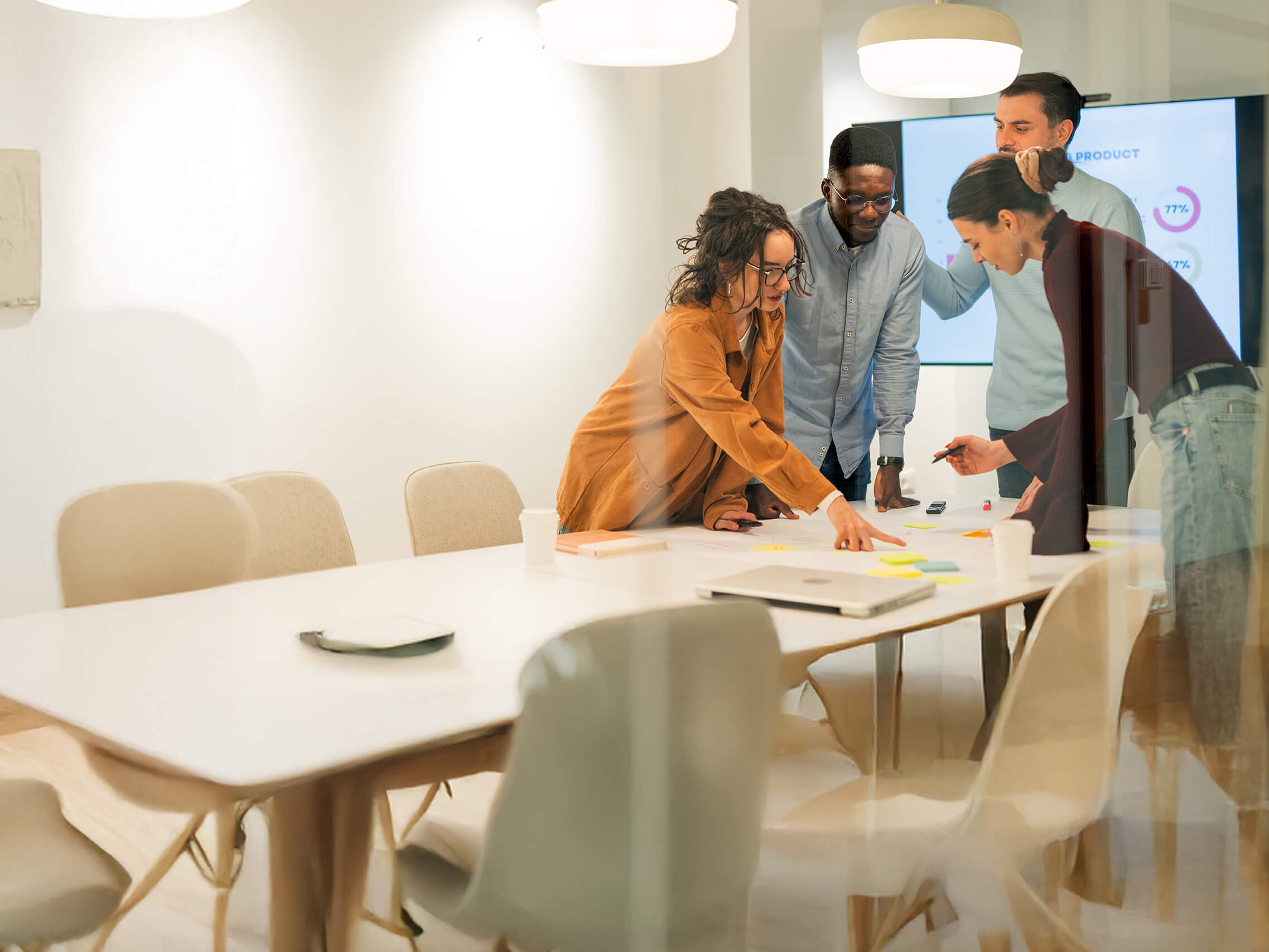 A group of collecgues in an office with glass walls 