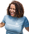 Smilling volunteer with curly hair in a pale blue tshirt