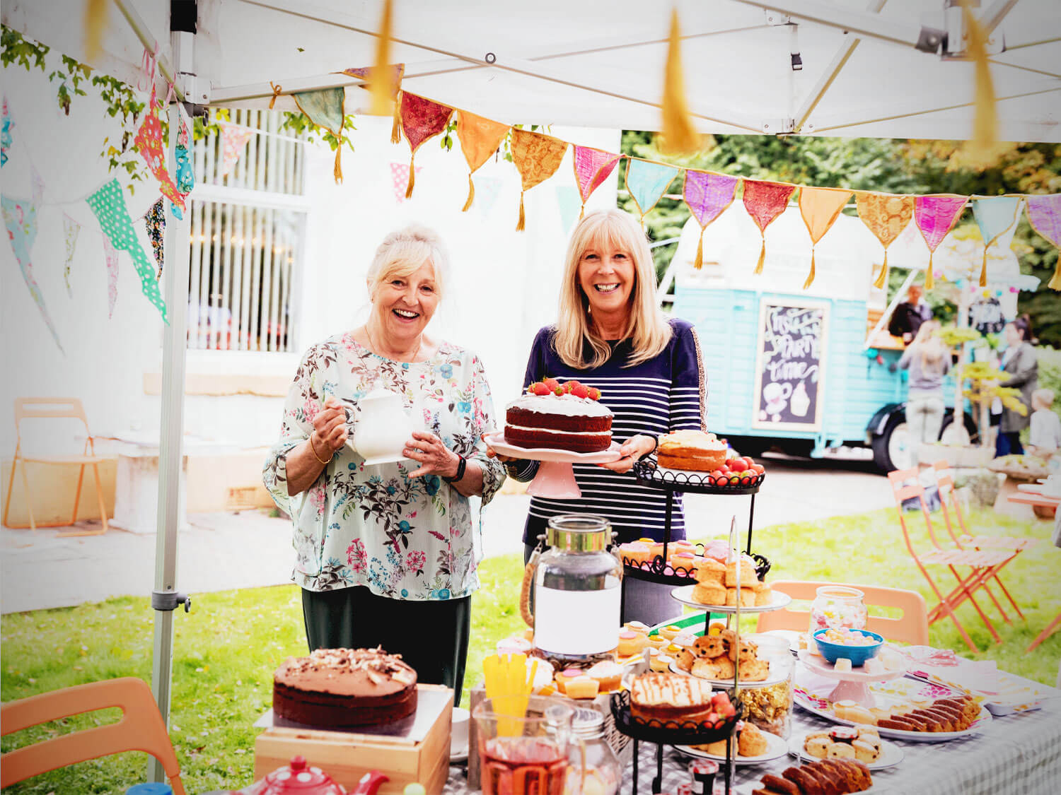 Two woman raising money at a Vintage Tea Party