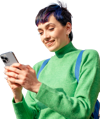 Woman in a green jumper looking at her mobile phone and smiling