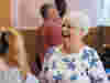 An older woman having a good time with friends at a community centre