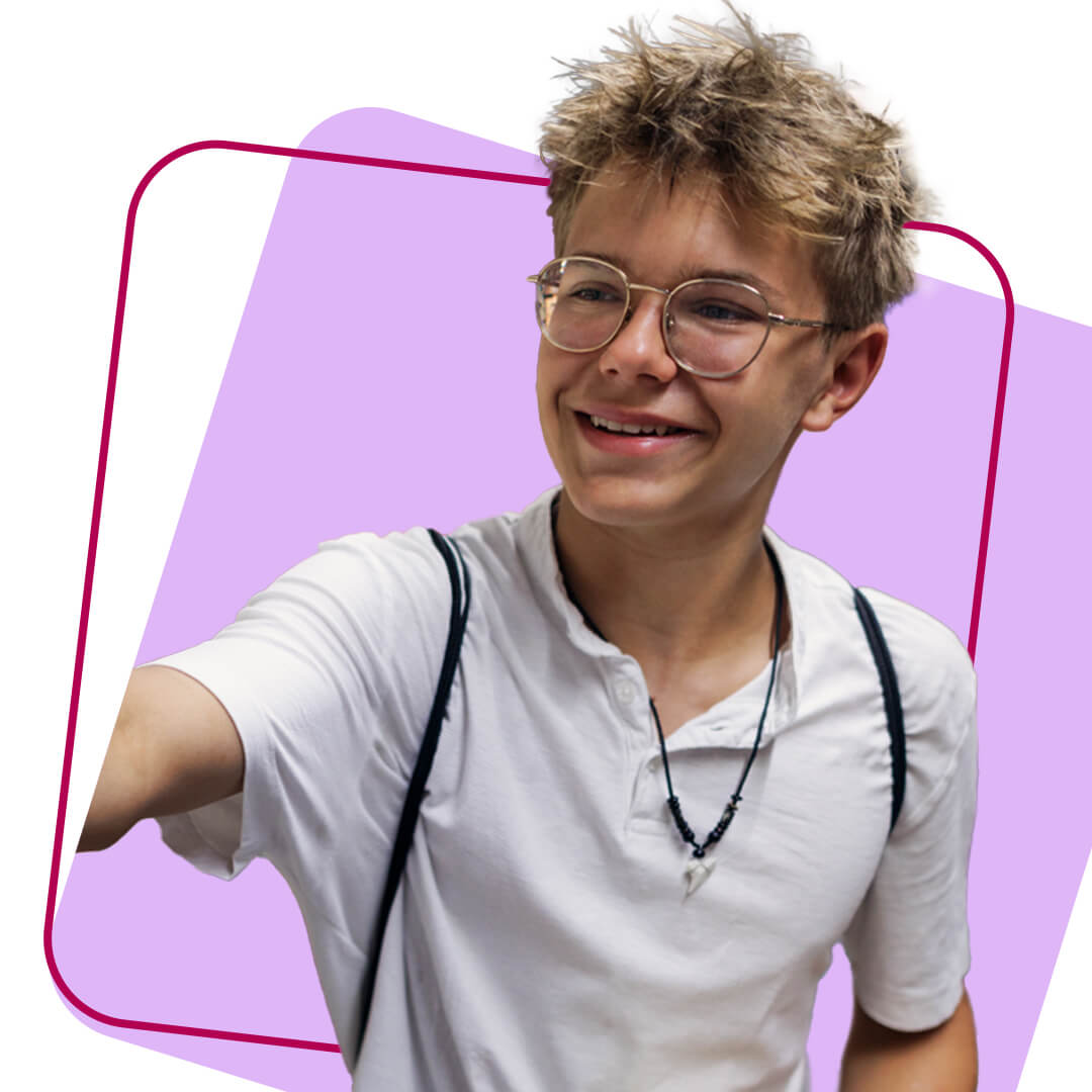 A young volunteer smiling in a cut out image against an lilac background 