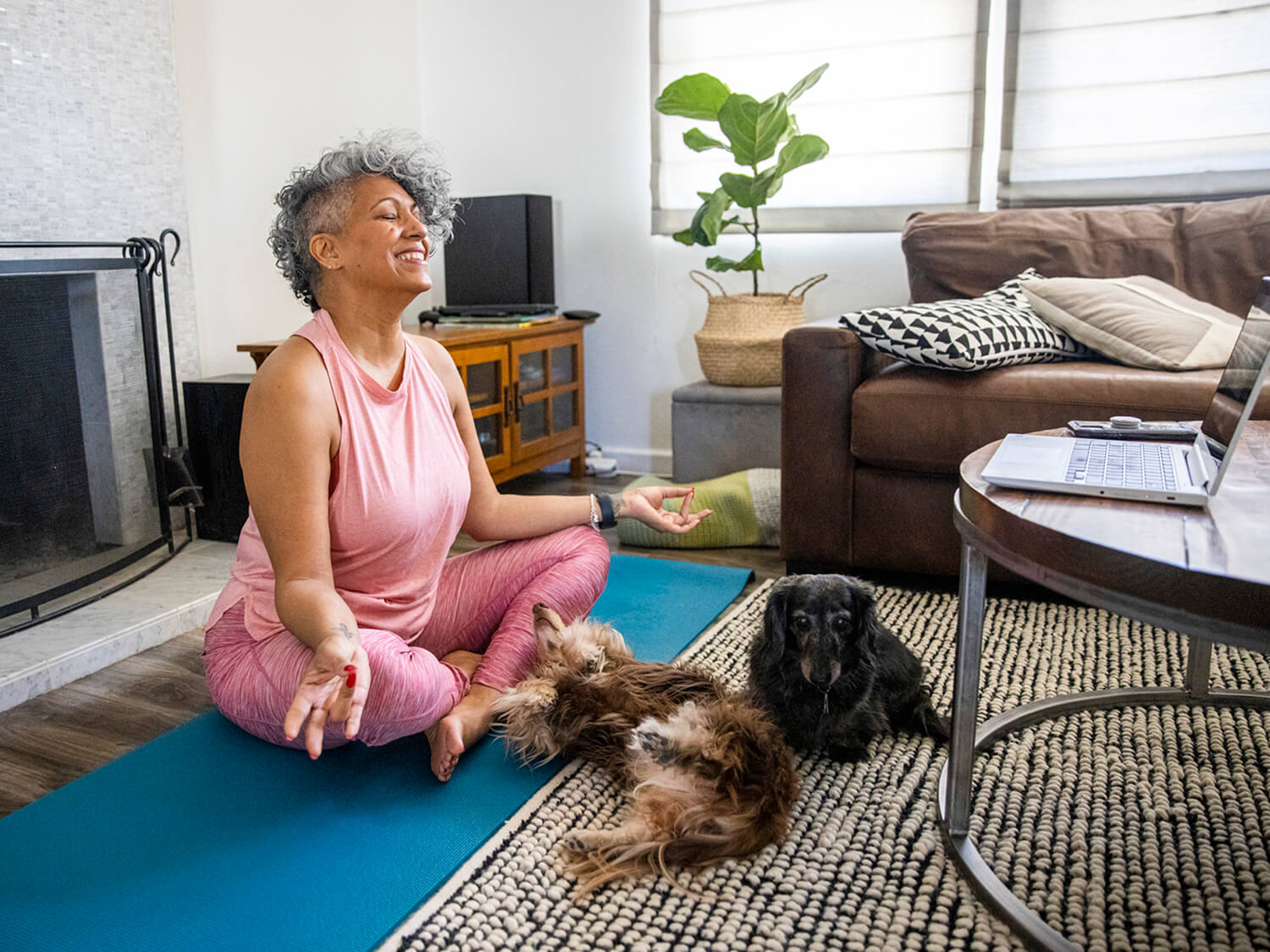 A older woman taking an online fitness class at home from the Virtual Village Hall 