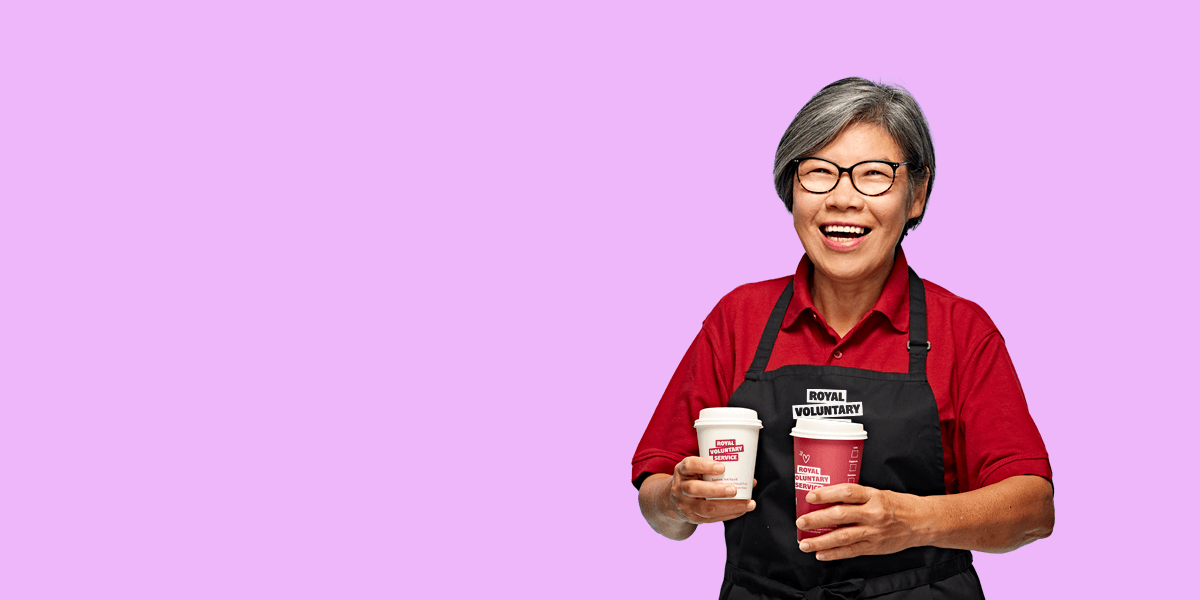 Portrait of volunteer Fui against an lilac background 