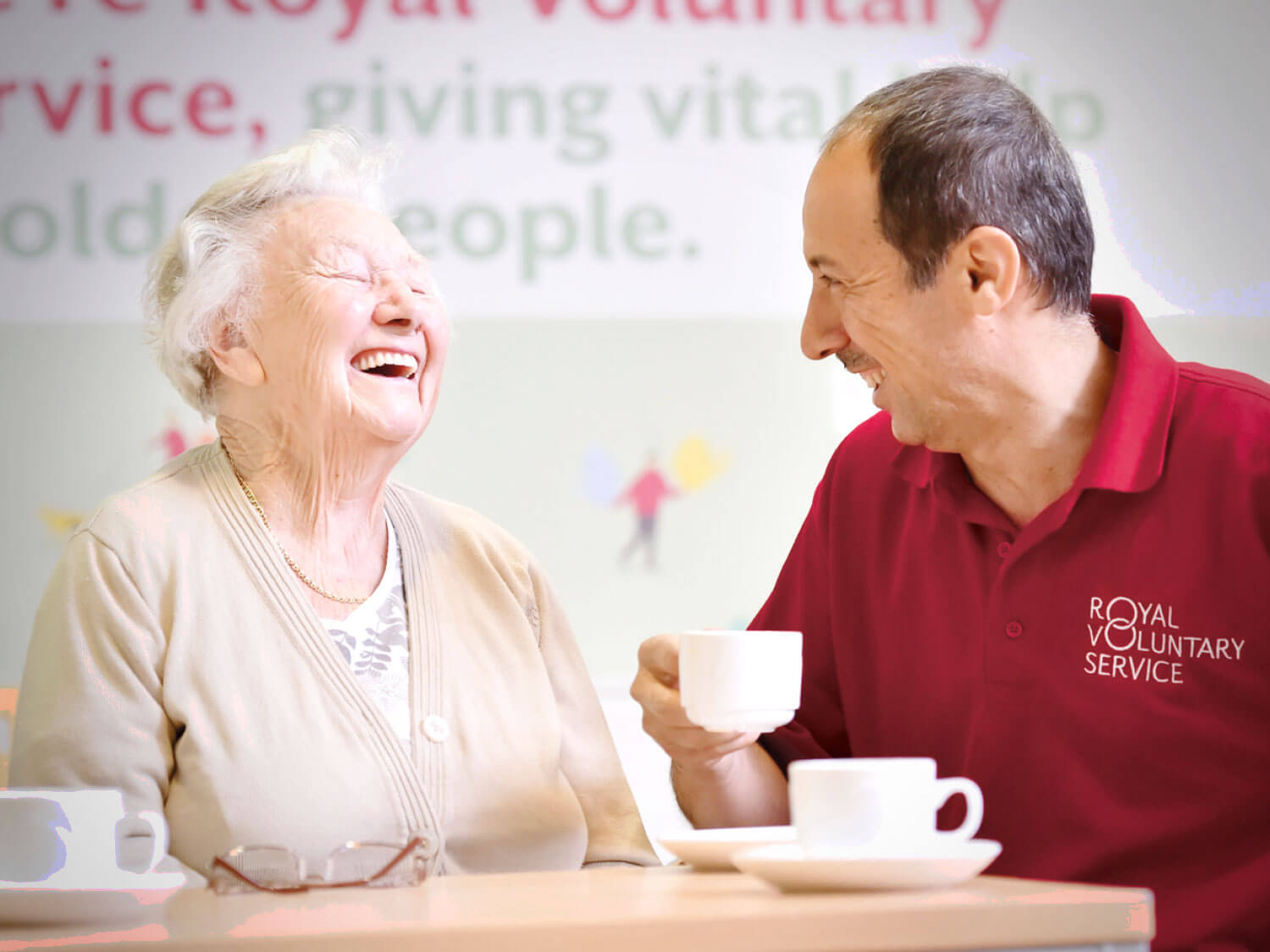 Joyce with a Royal Voluntary Service volunteer enjoying a cup of tea 