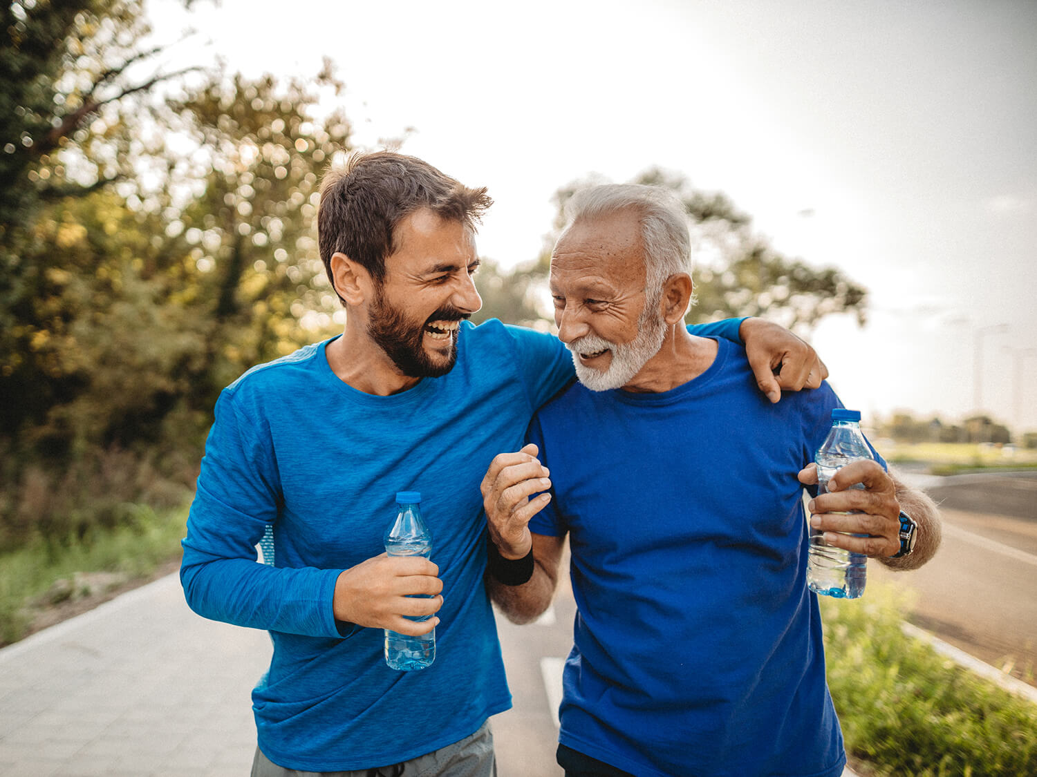 Two men on a run encouraging each other on 