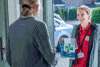 A female volunteer wearing a Royal Voluntary Service tshirt, delivering a prescription to someone at home